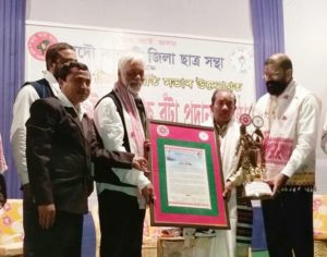 Folk artist Loknath Kutum being conferred with Mohan Bhaira Bota 