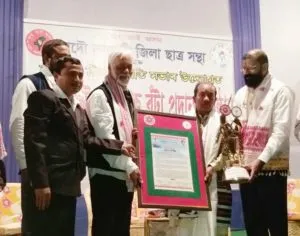 Folk artist Loknath Kutum being conferred with Mohan Bhaira Bota