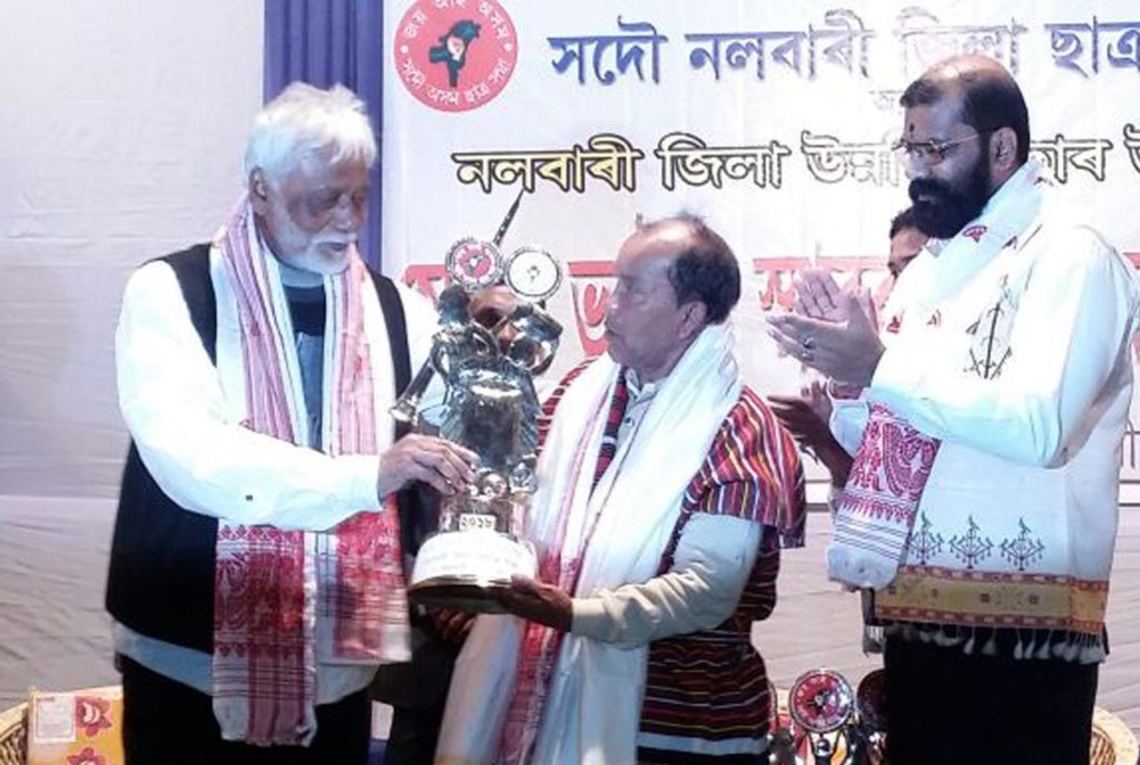 Folk artist Loknath Kutum being conferred with Mohan Bhaira Bota