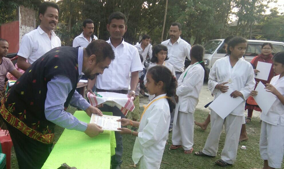 A young winner seen receiving certificates from a guest