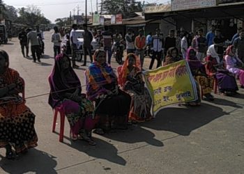Mid day meal workers bock national highway linking Silchar with Aizawl on Wednesday sitting on its route