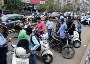 Police personal taking fine for violating traffic rules, at GS Road in Guwahati on Sunday.