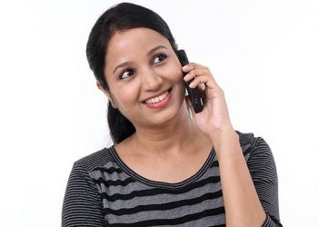 Happy young woman talking on mobile phone