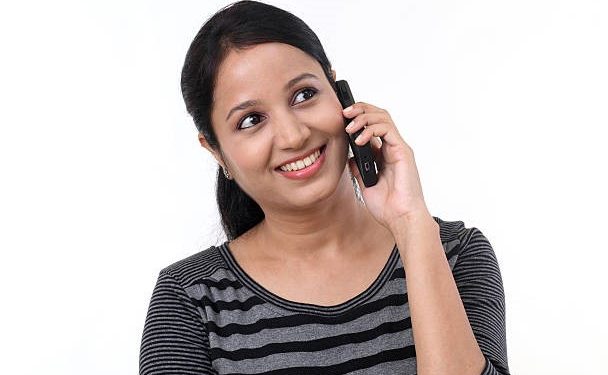 Happy young woman talking on mobile phone