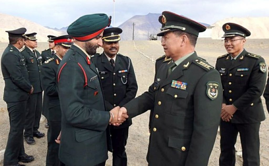 Indian Army officer Brigadier HS Gillshakes hand with Chinese PLA Senior Col Bai Min during a Ceremonial Border Personnel Meeting