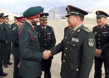 Indian Army officer Brigadier HS Gillshakes hand with Chinese PLA Senior Col Bai Min during a Ceremonial Border Personnel Meeting