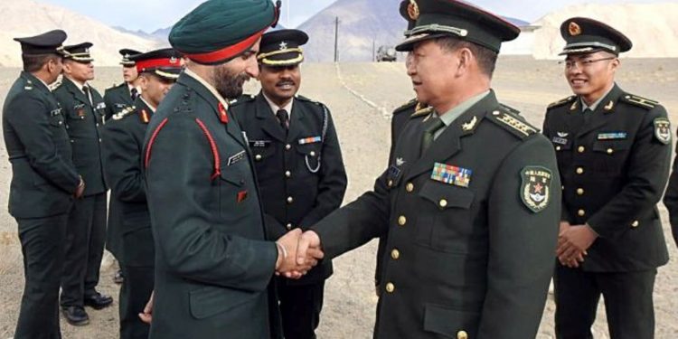 Indian Army officer Brigadier HS Gillshakes hand with Chinese PLA Senior Col Bai Min during a Ceremonial Border Personnel Meeting