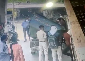 police taking dead body on a garbage van