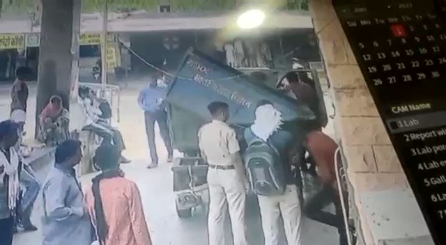 police taking dead body on a garbage van
