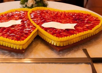 Man Using Sword To Cut Birthday Cake