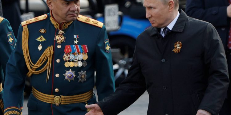 Russian President Vladimir Putin and Defence Minister Sergei Shoigu speak after a military parade on Victory Day, which marks the 77th anniversary of the victory over Nazi Germany in World War Two, in Red Square in central Moscow, Russia May 9, 2022. REUTERS/Maxim Shemetov