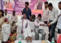 টেবুলৰ ওপৰত দুয়োখন ভৰি তুলি আৰাম কৰিলে মন্ত্ৰীয়ে! সমুখত নীৰৱে বহি ৰ’ল জনসাধাৰণ